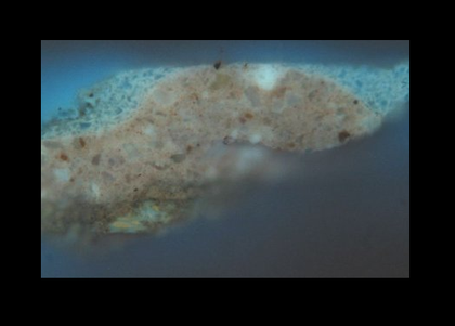 Fig.6 Cross-section through the sky, photographed at x260 magnification in ultraviolet light. From the bottom: pink ground; blue paint of the sky, which is a mixture of lead white, ultramarine and smalt