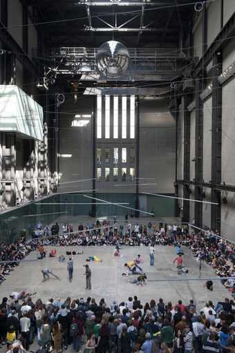 crowd of onlookers watching dancers in the centre of turbine hall
