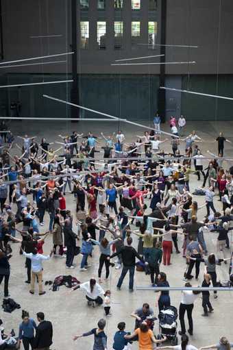 close up of dancers with arms outstretched in Turbine Hall