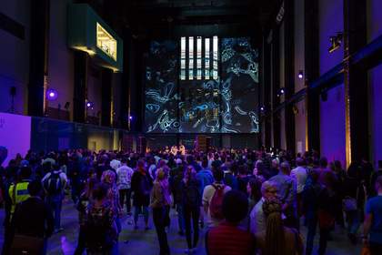 Crowd in Turbine Hall listening to a DJ