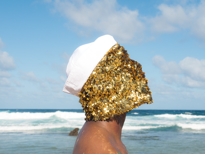 A person's profile with a sequin mask on