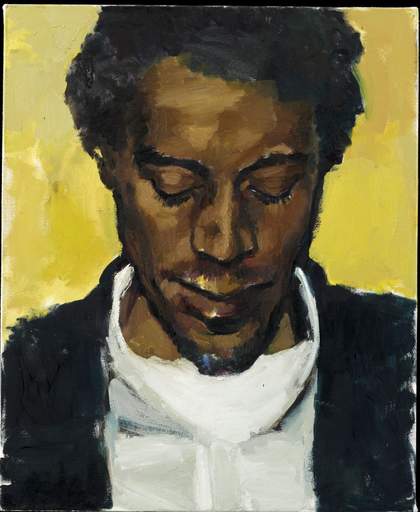 A man looks down, wears a white shirt, black jacket and is in front of a yellow background