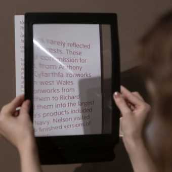a magnifier held over a wall text.