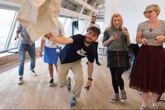 A man drawing on a piece of paper suspended in the air