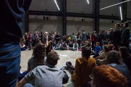 Crowd view of a female dancer lying and dancing on the floor
