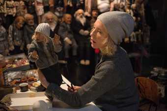 film still of cate blanchett with a puppet from film Manifesto