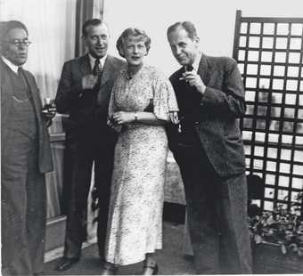 Marcel Breuer, Ise Gropius and Walter Gropius celebrating the first anniversary of the Isokon Flats on the building's rooftop, Lawn Road, Belsize Park, London, 1935