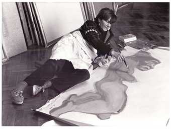 Photo of Maria Lassnig painting in her studio, Vienna 1982
