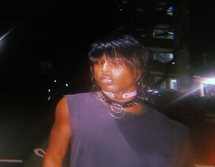 blurred image of a person in a tank top looking out past the camera
