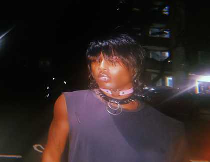 blurred image of a person in a tank top looking out past the camera