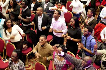 Chloe Dewe Mathews House of Praise, Camberwell showing people in a black church standing up and singing