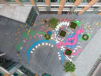 birds eye view of a mural of abstract shapes painted on the ground 