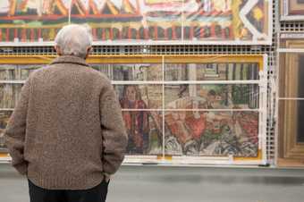 A person looking at an artwork in Tate Stores