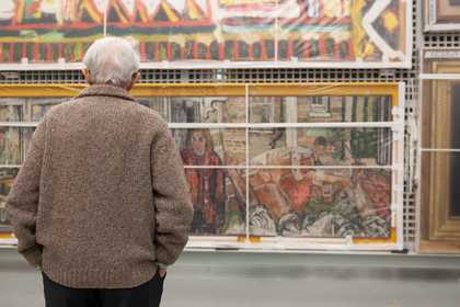 A person looking at an artwork in Tate Stores