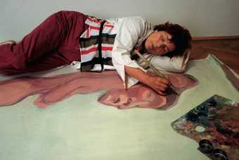 Maria Lassnig painting in her studio in Vienna, 1983, photographed by Michael Westermann