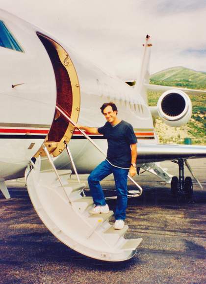 Photograph of a man climbing the steps into a small plane