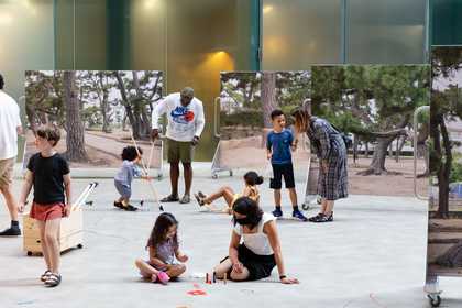 Children and adults draw on the floor of the turbine hall