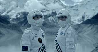 Two characters in space suits against a snowy mountain backdrop.