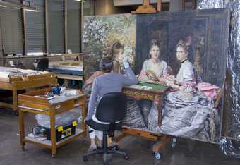 Natasha Duff carrying out varnish removal in the Paintings Conservation studio. 