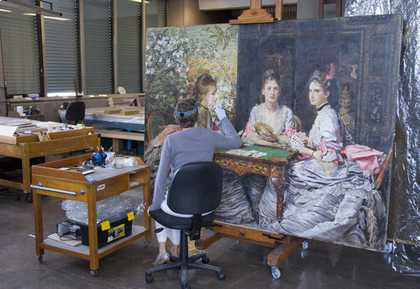 Natasha Duff carrying out varnish removal in the Paintings Conservation studio.