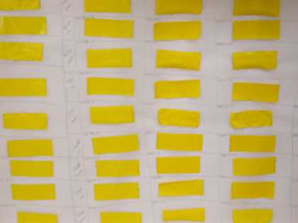 Selection of yellow acrylic paint films after immersion in cleaning solutions and ready for testing