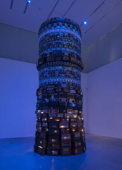 A large tower of individual radios lit with blue light