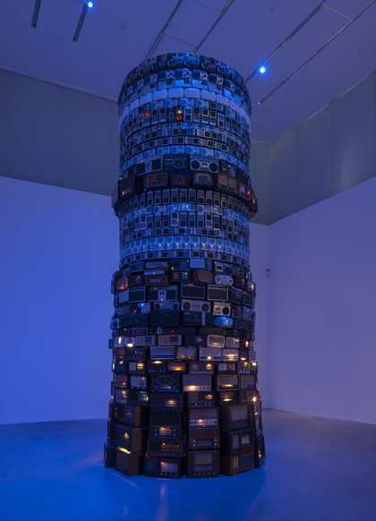 A large tower of individual radios lit with blue light
