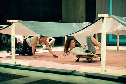 Rolling underneath a reproduction of Jutta Koether's painting La Femme, 2006 during Ei Arakawa's Kissing the Canvas performance 
