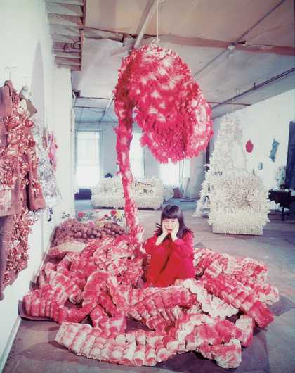 Yayoi Kusama lying on the base of My Flower Bed