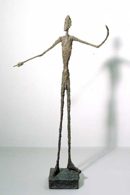 Standing wire figure by Alberto Giacometti with a shadow behind it