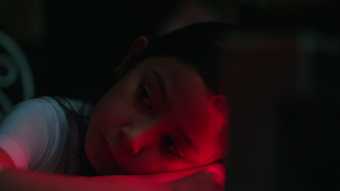 portrait of a young girl lit with red light