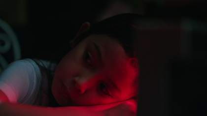 portrait of a young girl lit with red light