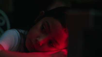 portrait of a young girl lit with red light