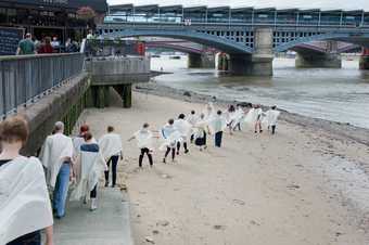 A group of people on the bank of the Thames