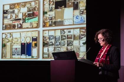 A speaker presents a slideshow to the audience