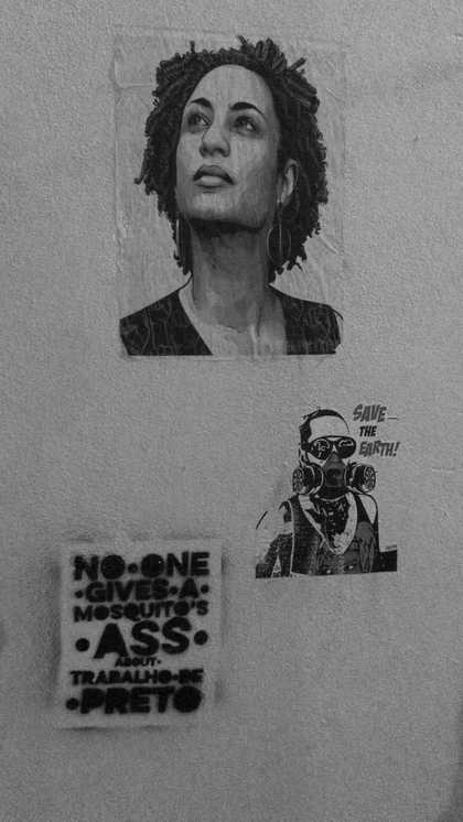 a wall with three pinned up images, including a portrait of a woman