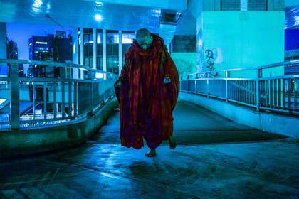 A red-robbed monk walking in Tokyo