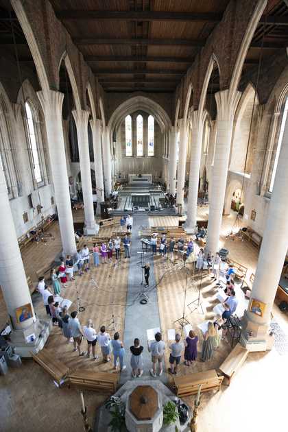 40-person choir standing in a circle, photographed from high above