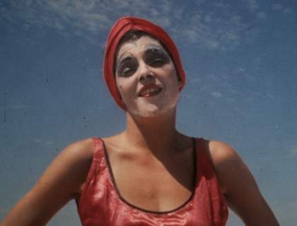a woman with a face mask on stares at the camera