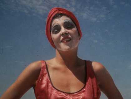 a woman with a face mask on stares at the camera