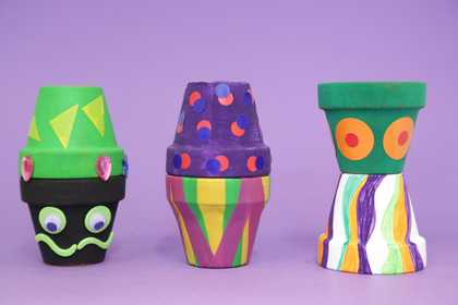 Photograph of six painted plant pots 