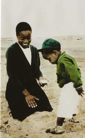 Woman and boy standing together on shore