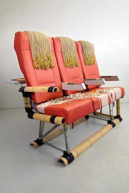 Airline passenger seat covered with material