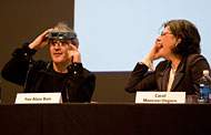 Two people speaking on an event panel