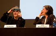 Two people speaking on an event panel