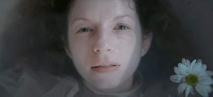 A woman's face partially submerged in water