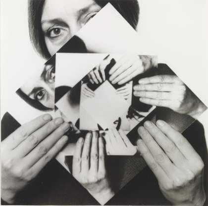 black and white self portrait of the artist holding smaller versions of the self portrait slightly rotated