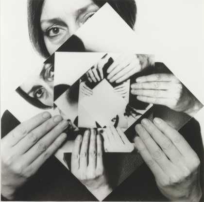 black and white self portrait of the artist holding smaller versions of the self portrait slightly rotated