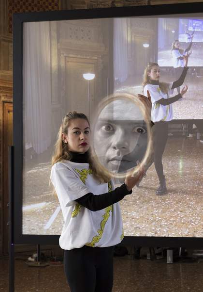 Performer holding a mirror