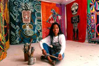 photo of Pacita Abad surrounded by her artworks